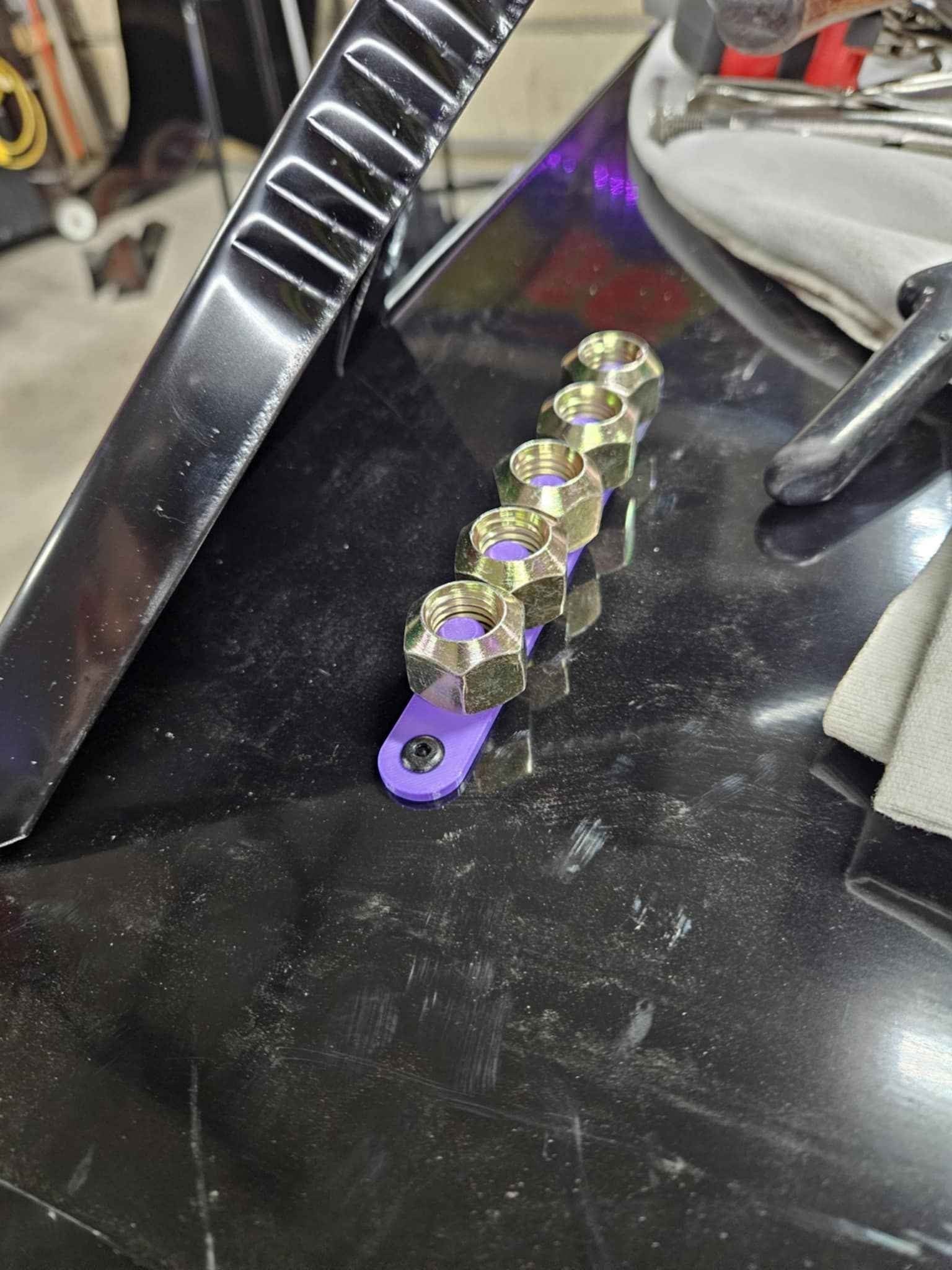 Z3 Designs purple lug nut holder with 5 gold lug nuts for pit stops